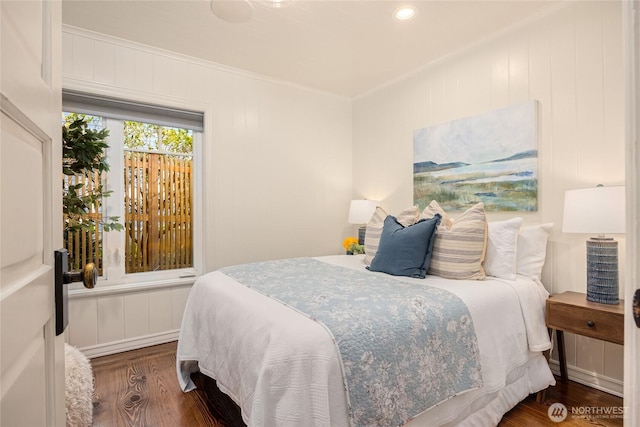 bedroom featuring crown molding and wood finished floors