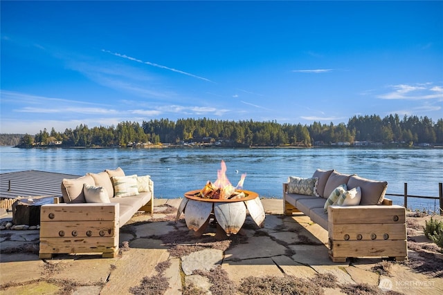 water view featuring a forest view and a fire pit