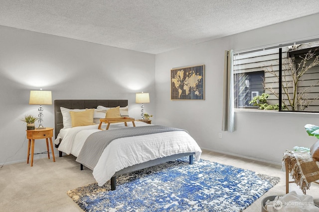 carpeted bedroom featuring a textured ceiling and baseboards