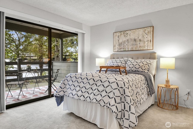 carpeted bedroom featuring a textured ceiling and access to outside