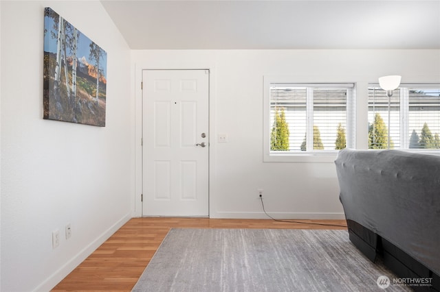 entrance foyer with wood finished floors and baseboards