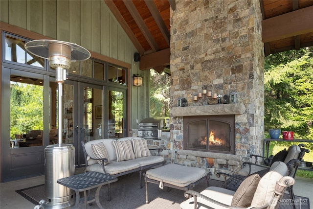 view of patio / terrace with french doors, a grill, and an outdoor living space with a fireplace