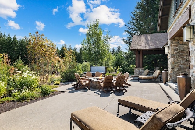 view of patio featuring an outdoor living space with a fire pit