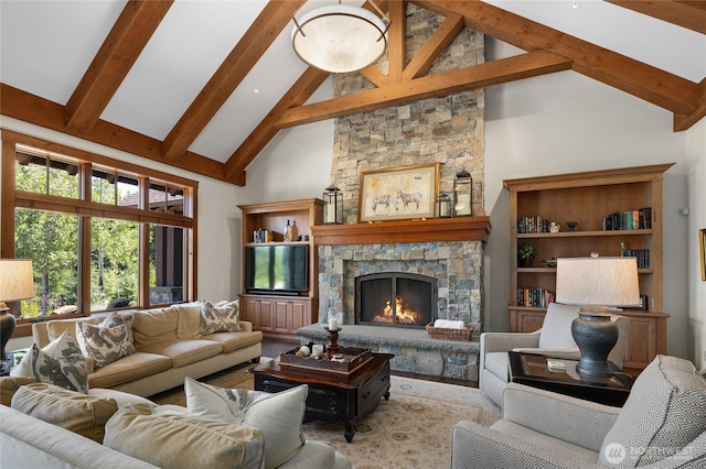 living area with high vaulted ceiling, beamed ceiling, and a stone fireplace