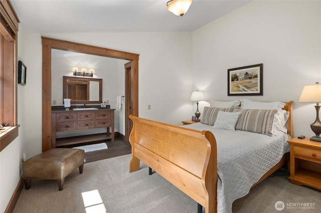 bedroom with lofted ceiling, carpet flooring, and baseboards