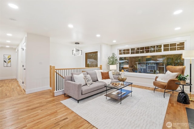 living room featuring light wood-style floors, recessed lighting, and baseboards