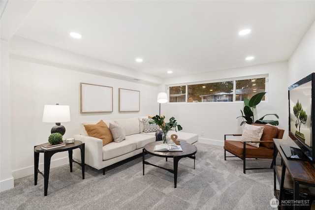 carpeted living room featuring baseboards and recessed lighting