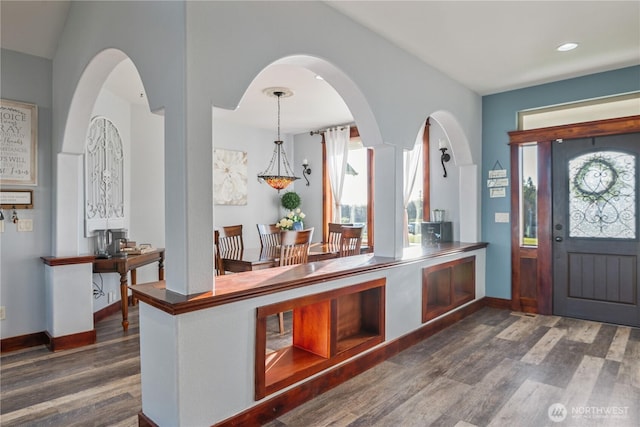 foyer with plenty of natural light, baseboards, and wood finished floors