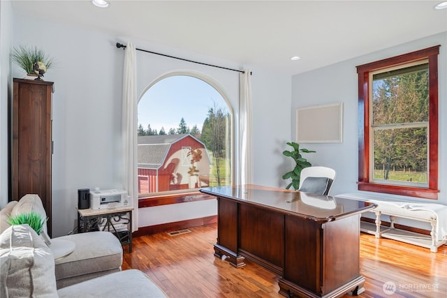 office with plenty of natural light, wood-type flooring, and recessed lighting