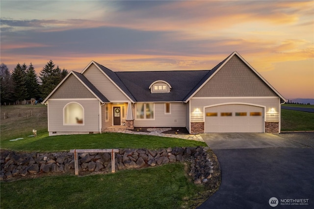 craftsman inspired home featuring an attached garage, stone siding, concrete driveway, and a yard