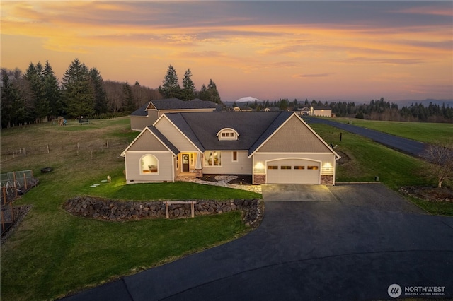 view of front facade featuring a garage, concrete driveway, stone siding, and a front yard