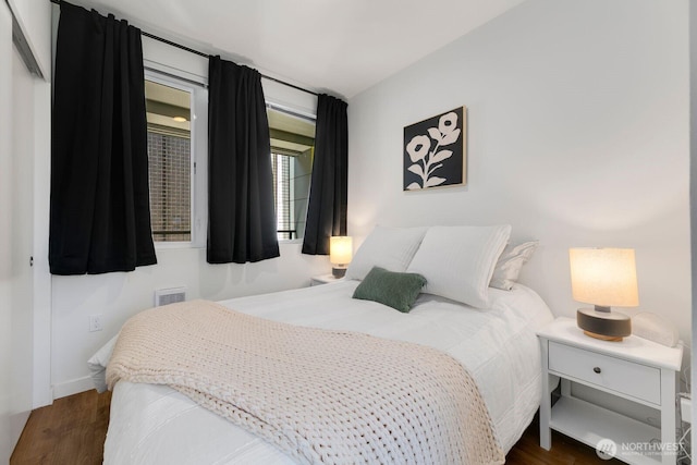 bedroom featuring wood finished floors and visible vents