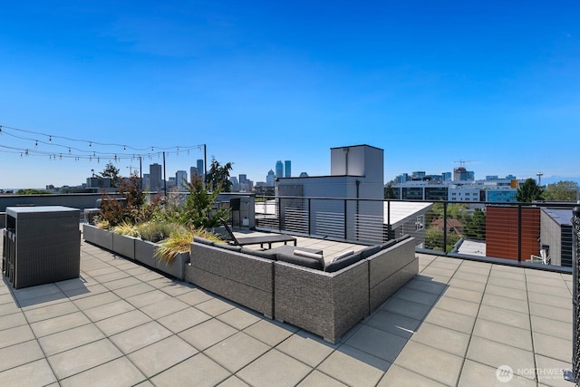 view of patio with a balcony, an outdoor living space, and a city view