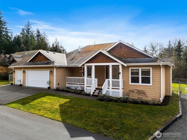 view of front of house featuring a front yard, driveway, an attached garage, covered porch, and crawl space