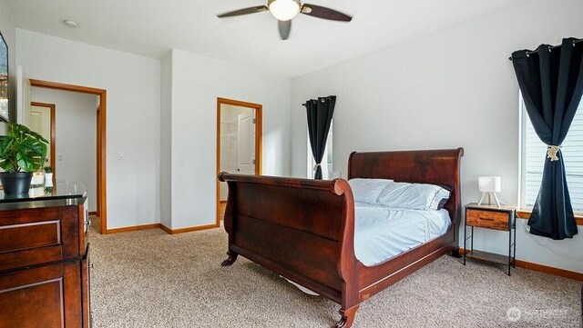 bedroom with light colored carpet, baseboards, and ceiling fan