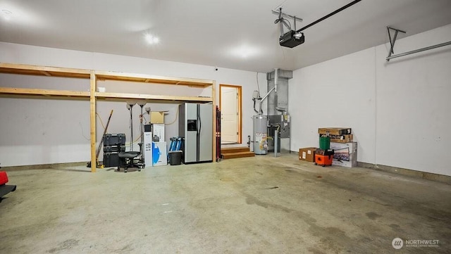 garage featuring gas water heater, a garage door opener, and stainless steel fridge