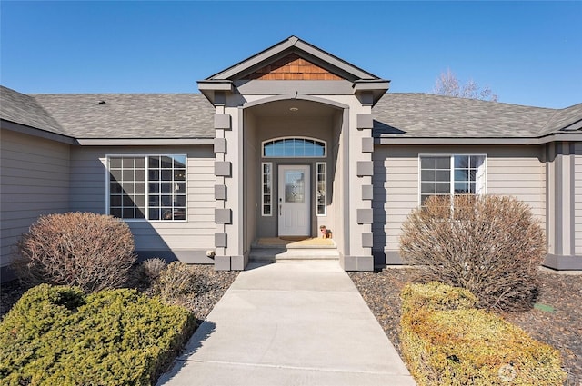 entrance to property with roof with shingles