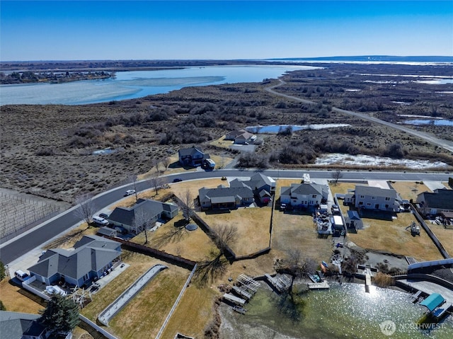 drone / aerial view with a residential view and a water view