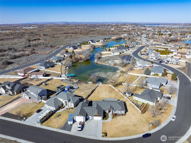 birds eye view of property featuring a water view and a residential view