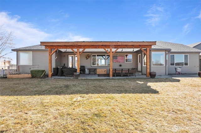 rear view of property featuring a patio and a lawn