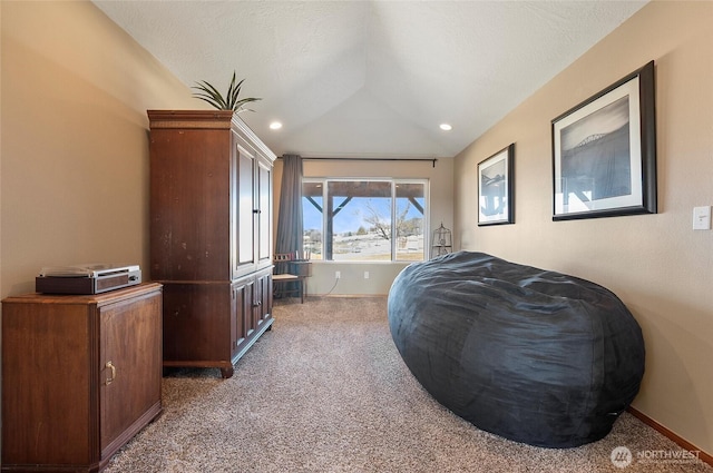 bedroom with carpet floors, vaulted ceiling, a textured ceiling, and baseboards