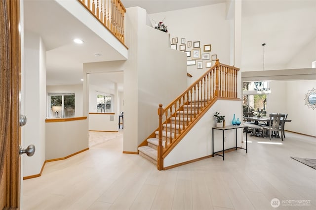 22426 SE 300th St, Black Diamond, WA 98010 - staircase featuring a towering ceiling, a notable chandelier, and a wealth of natural light