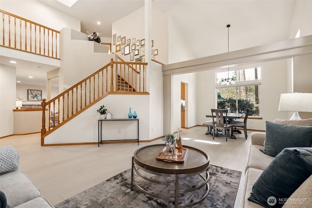 22426 SE 300th St, Black Diamond, WA 98010 - living room featuring a towering ceiling, a notable chandelier, stairs, and wood finished floors