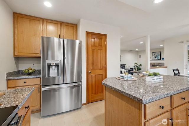 22426 SE 300th St, Black Diamond, WA 98010 - kitchen featuring stainless steel fridge with ice dispenser, stone counters, recessed lighting, and a kitchen island