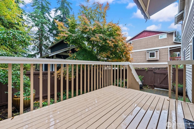 wooden terrace featuring fence