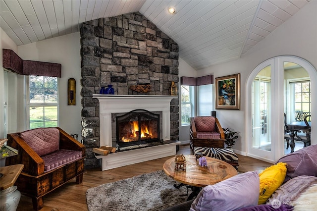 sitting room featuring a healthy amount of sunlight, a fireplace, wood finished floors, and lofted ceiling