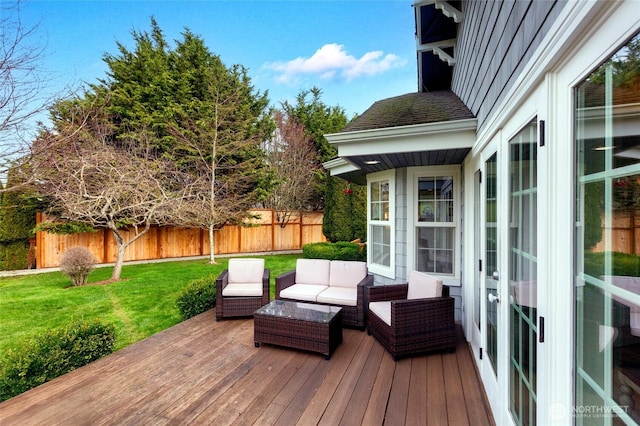 wooden deck with fence, outdoor lounge area, and a lawn