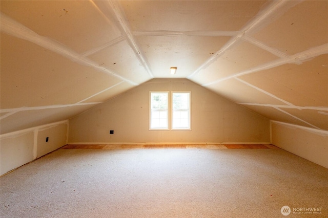 additional living space featuring vaulted ceiling