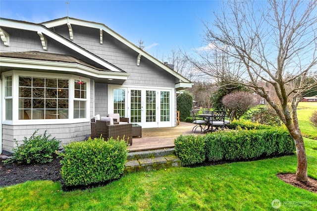 back of property featuring french doors, a lawn, and a wooden deck