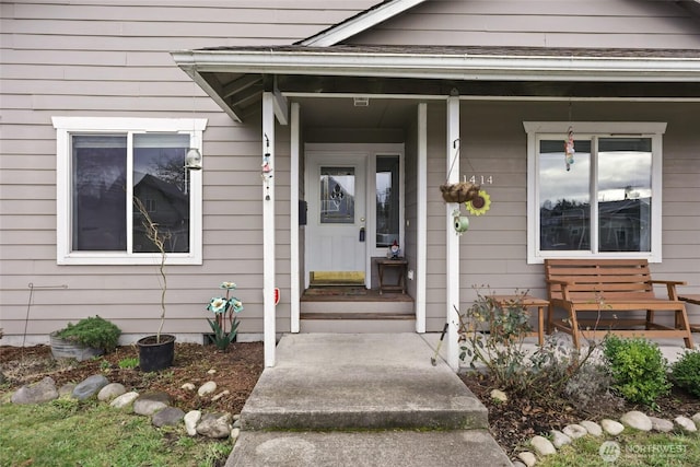 view of exterior entry with a porch