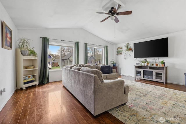 living area featuring dark wood-style floors, lofted ceiling, ceiling fan, and baseboards