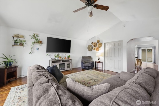 living room with lofted ceiling, wood finished floors, and a ceiling fan