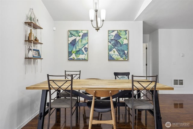 dining area featuring baseboards, visible vents, and wood finished floors