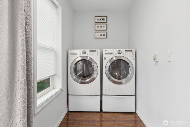 washroom featuring laundry area, independent washer and dryer, dark wood finished floors, and baseboards