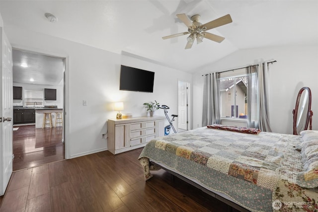 bedroom with baseboards, dark wood finished floors, ceiling fan, vaulted ceiling, and a sink