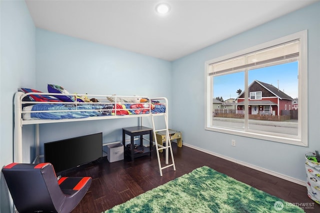 bedroom featuring wood finished floors and baseboards