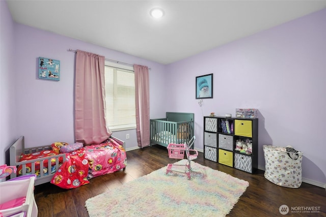 bedroom with recessed lighting, wood finished floors, and baseboards