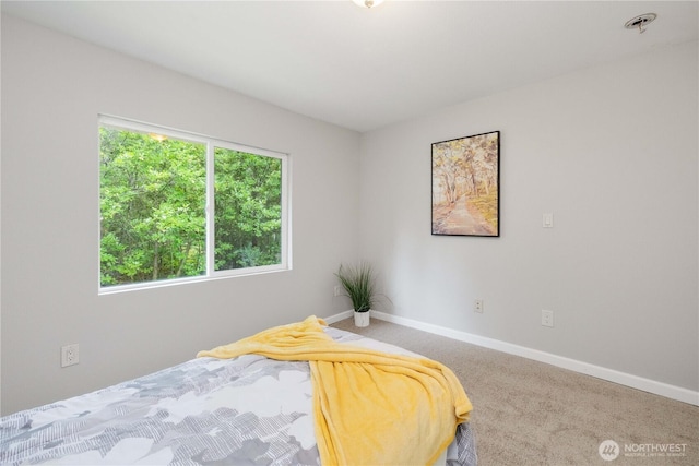 bedroom with baseboards and carpet flooring