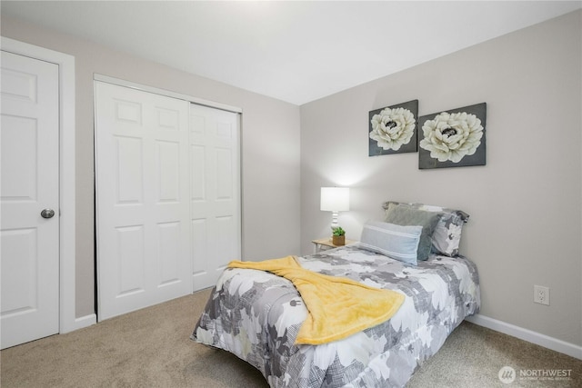 bedroom featuring carpet, baseboards, and a closet