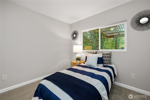 bedroom featuring carpet and baseboards