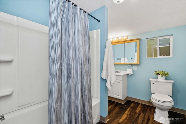 full bathroom with shower / tub combo, baseboards, toilet, wood finished floors, and vanity