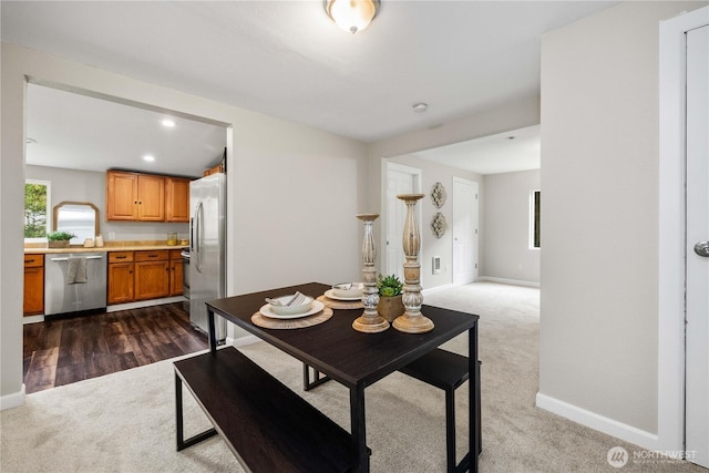 dining space featuring recessed lighting, dark carpet, and baseboards