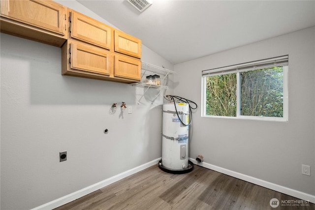 laundry room featuring visible vents, baseboards, water heater, cabinet space, and electric dryer hookup