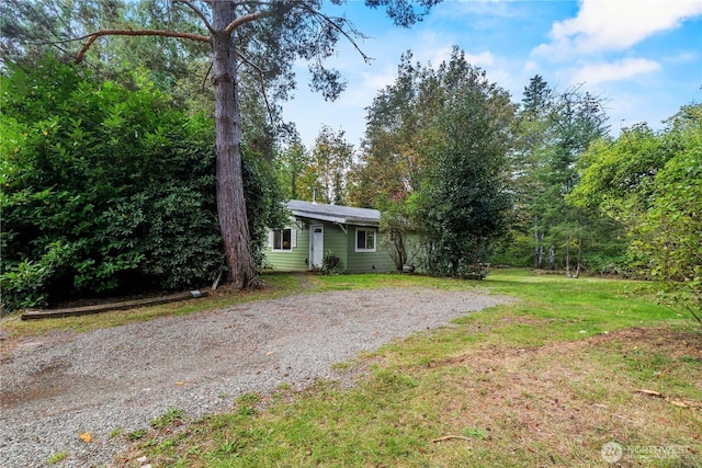 exterior space with driveway and a front lawn