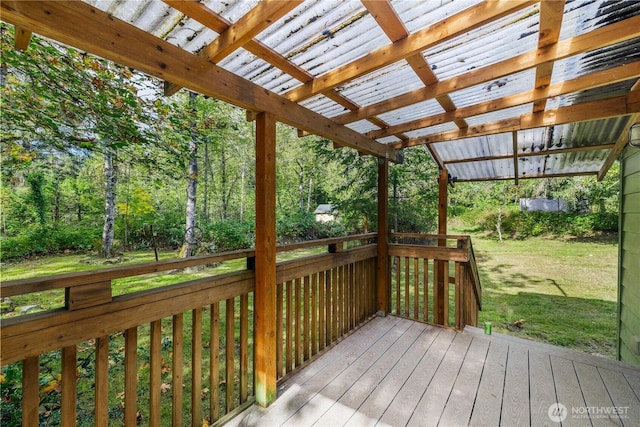 wooden terrace featuring a yard and a pergola