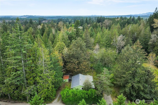 birds eye view of property with a forest view